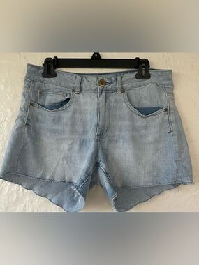 American Eagle women’s mid rise mid wash distressed hem cut off denim shorts; 10